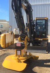 Mini excavator shown with brush cutter attachment and screen guard