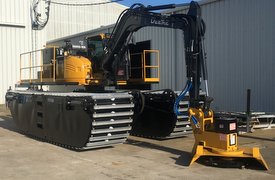 Mini excavator with brush cutter and new amphibious undercarriage, with extra power from a powerpack