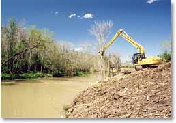 A drainage district mulches trees to reduce flooding